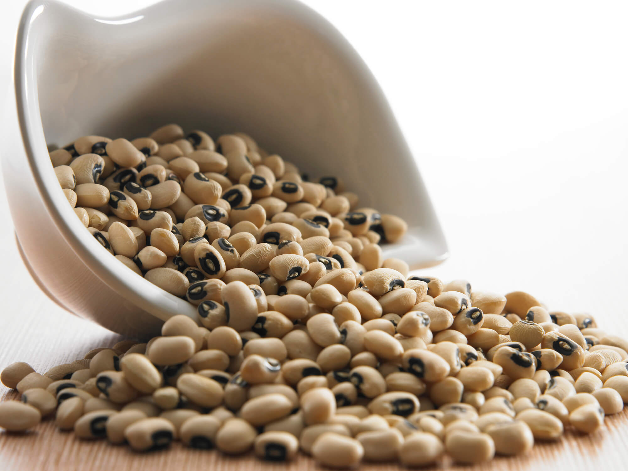Close-Up Of Black-Eyed Peas In Bowl On Table Against White Background