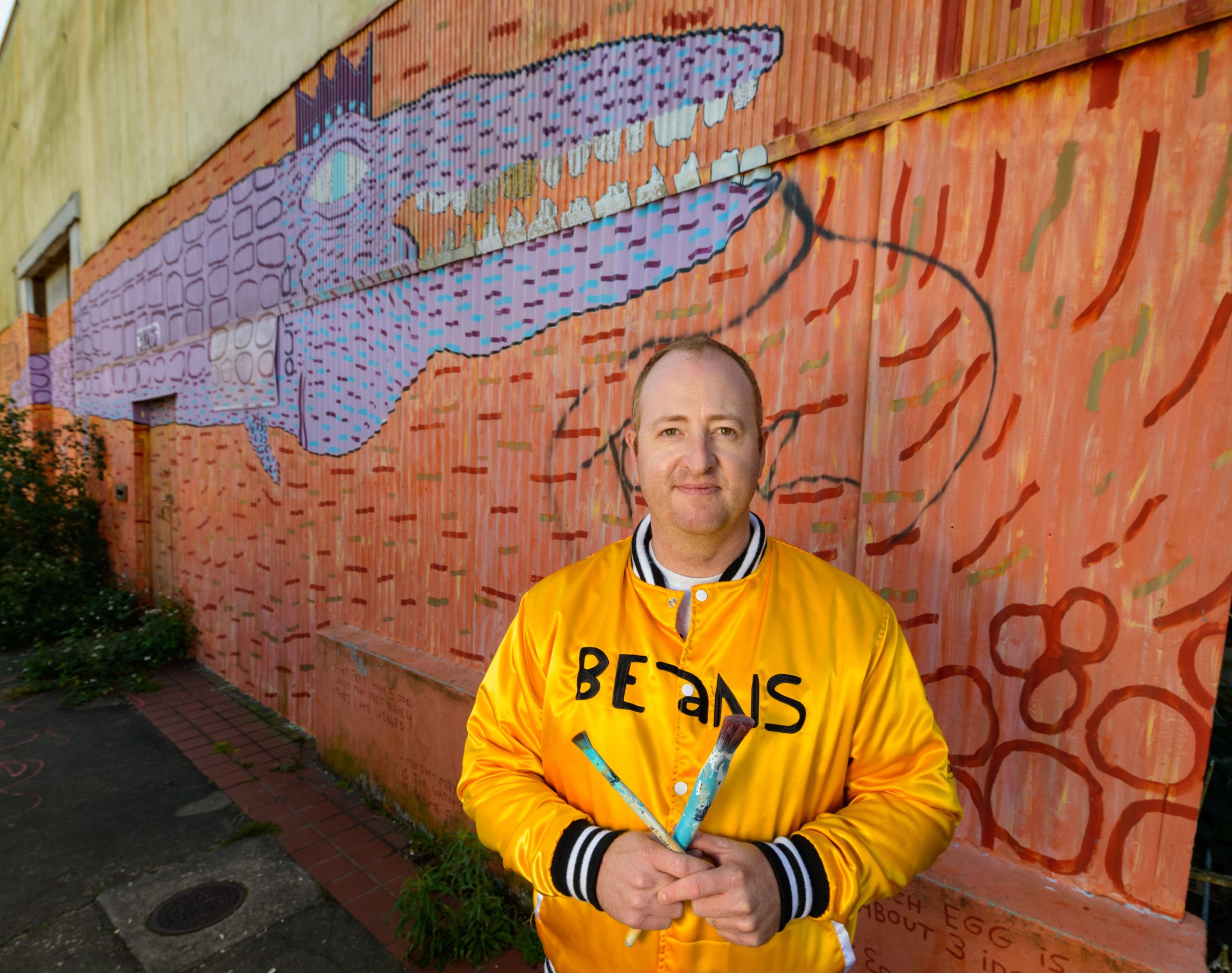 Krewe of Red Beans founder Devin De Wulf likes to find projects that are win-win for his community and creating art like this giant mural called Nnamdi the Gator, that he painted for one of his Bywater neighbors in New Orleans. Photo by Matthew Hinton