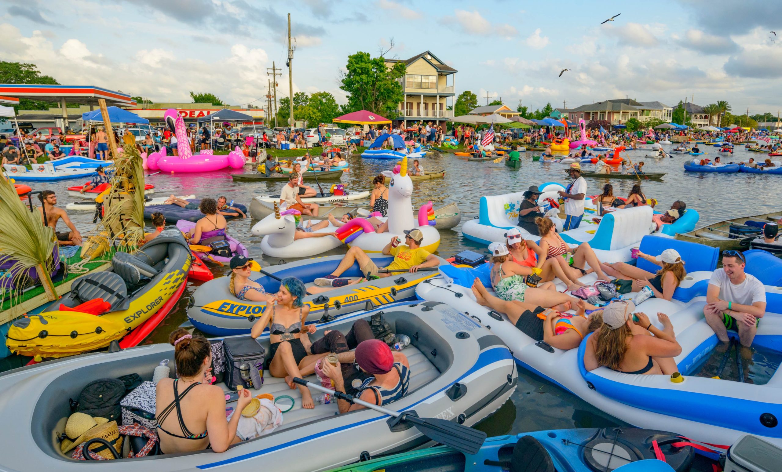 People float on Bayou St. John during the Mid-City Bayou Boogaloo in New Orleans, La. Saturday, May 18, 2019. Described as a mini-Jazz Fest the now three day festival features New Orleans music, art, cuisine and culture. The event was created in 2006 to reinvigorate the Mid City neighborhood after Hurricane Katrina. Photo by Matthew Hinton