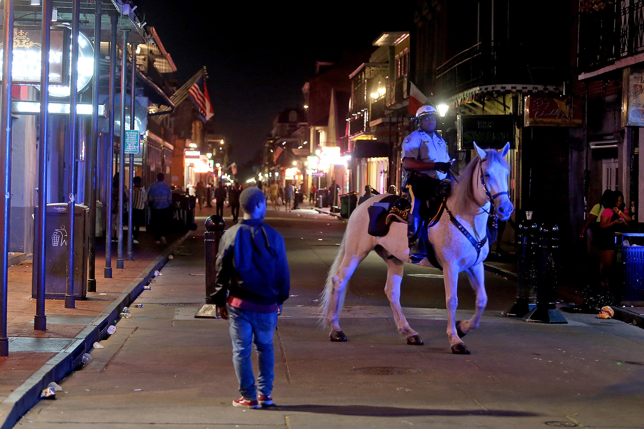 A mounted NOPD officer rides on a nearly empty Bourbon Street at 12:30 a.m. as the city of New Orleans issues new rules about bar and restaurant operations in the city in response to the Covid-19 pandemic on Monday, March 16, 2020.