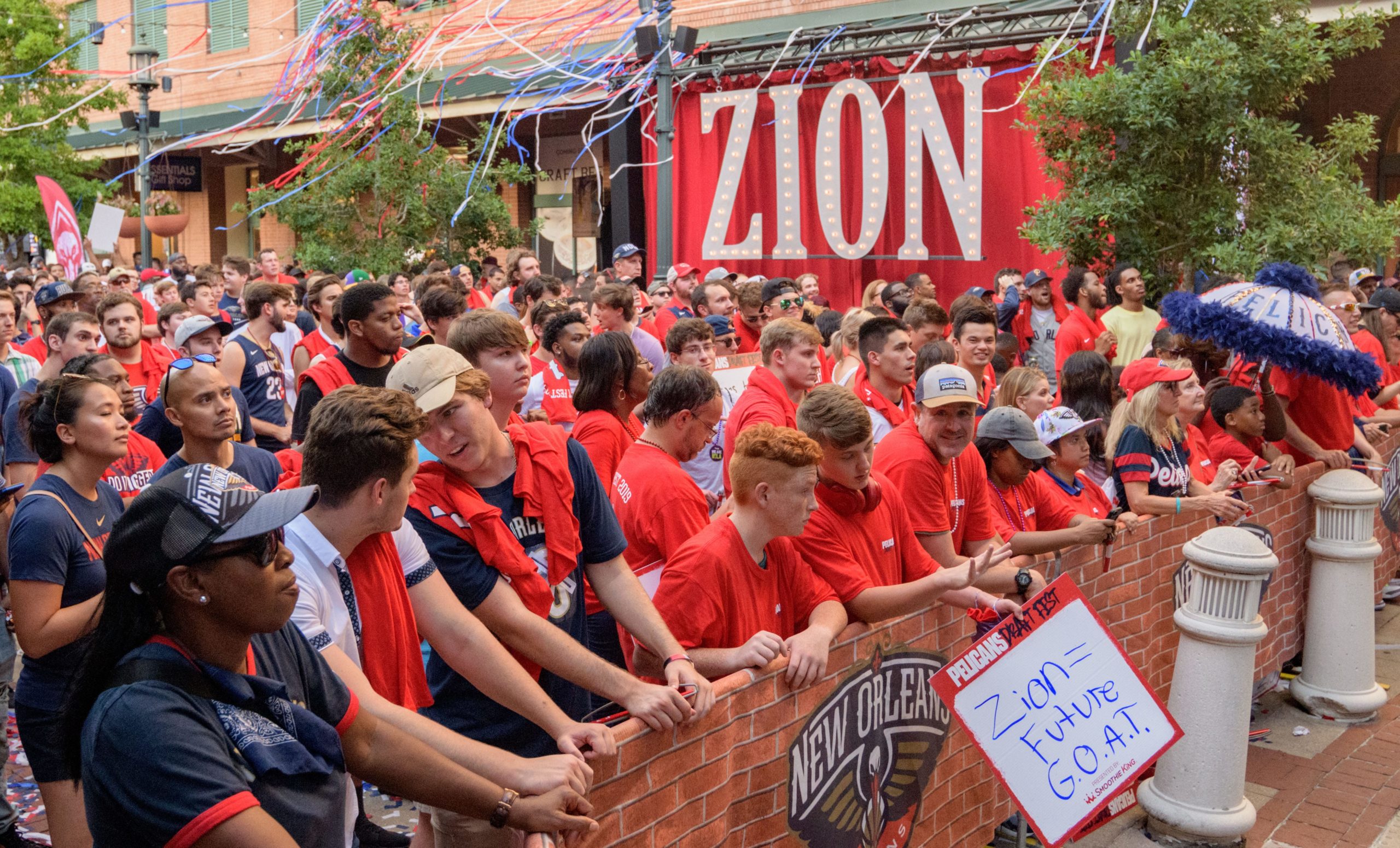 Fans hang out in Fulton Square during the announcement of the New Orleans Pelicans drafting Zion Williamson number one in the NBA draft outside Manning's Restaurant in Fulton Square in New Orleans, La. Thursday, June 20, 2019. Manning's is run by Archie Manning, the first round draft pick of the New Orleans Saints in 1971 and the father of two number one NFL draft picks with his sons Eli and Peyton Manning who were both born in New Orleans. Photo by Matthew Hinton