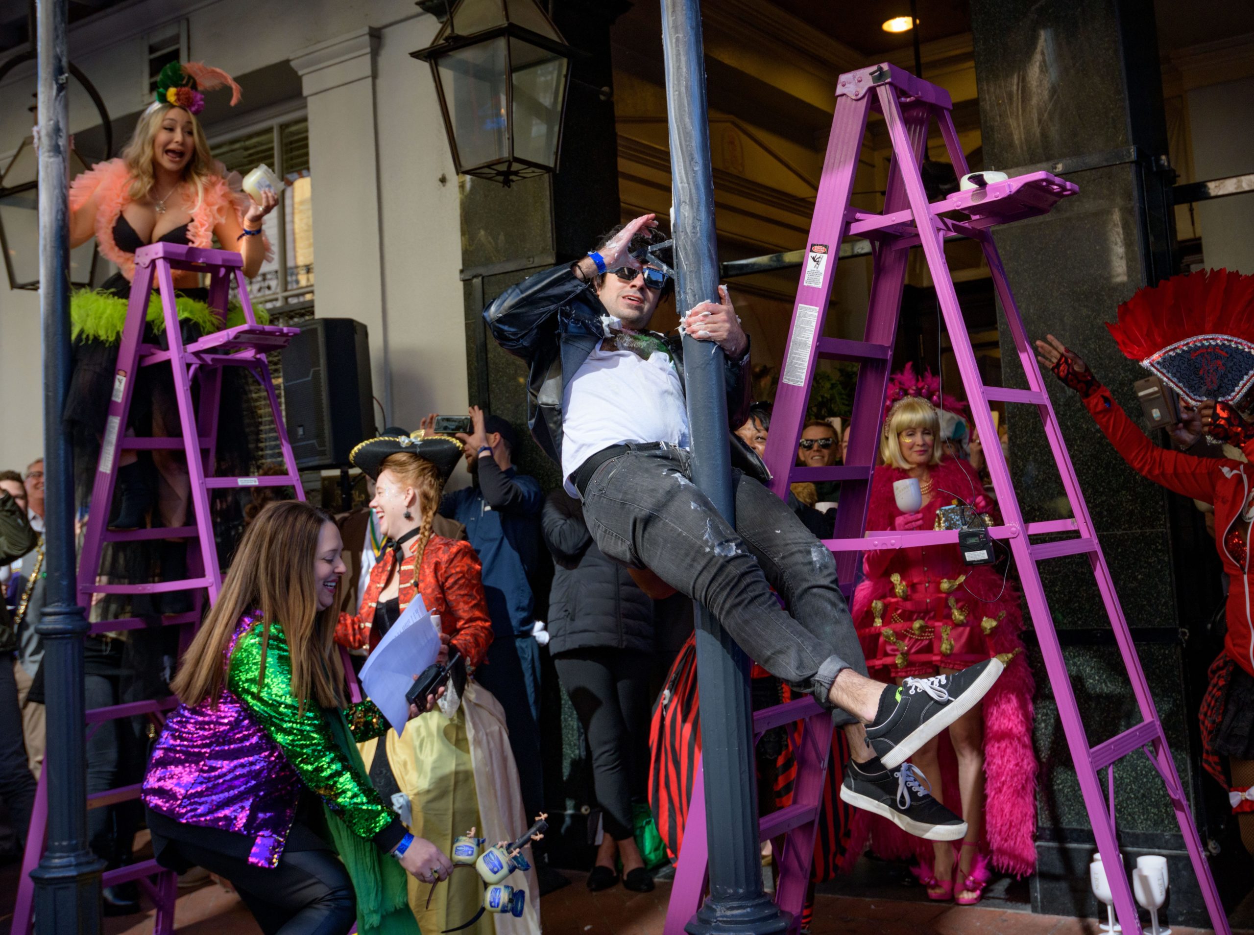 The tradition of greasing down poles at the Royal Sonesta Hotel in the French Quarter to keep parade-goers from shimmying up hotel balconies turns 50 this year. Known as the official kick off to Mardi Gras weekend, this event featured actor Bryan Batt as host and included appearances by Kenny Lopez from News with a Twist, who won this year, last year's winner Desiree Ontiveros of Bad Ass Balloons wearing "Bitch Please" eyelashes, Miss New Orleans Pride 2020 Lana O'Day in shiny purple dress, Reagan Charleston Thomas of Southern Charm New Orleans, musician Amanda Shaw dressed as Charlie Chaplin's Tramp, and renowned Big Easy burlesque dancer and performer, Trixie Minx. Leroy Jones and the Original Hurricane Brass Band entertained the crowd with special guests from the Merry Antoinettes, the Mystic Krewe of Femme Fatale, the Krewe of NOMTOC (New Orleans' Most Talked Of Club) and the Krewe of Cork. Photo by Matthew Hinton