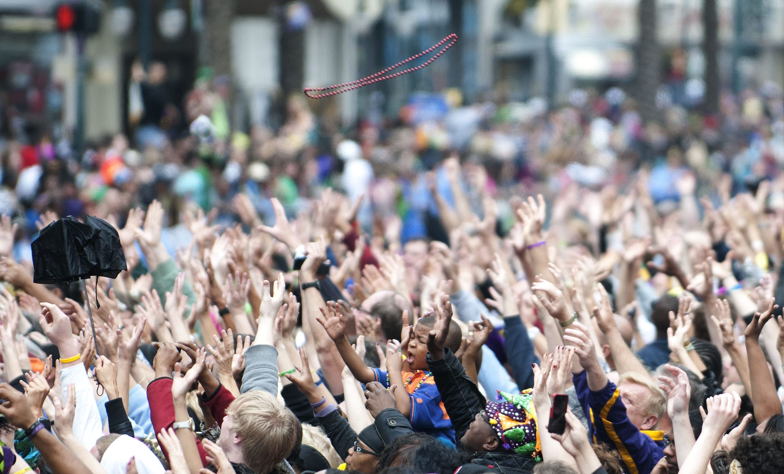 People reach for beads and other throws as the Krewe of Zulu turns onto Canal Street from St. Charles Avenue during the Mardi Gras parade on Fat Tuesday in New Orleans, LA, March 8, 2011.   Mardi Gras, or Fat Tuesday, is the final day of Carnival, and the day before Ash Wednesday, the first day of Lent. It's been celebrated in Louisiana since the late 17th century when it was under French colonial rule. AFP PHOTO /  ROD LAMKEY JR (Photo credit should read ROD LAMKEY JR/AFP/Getty Images)