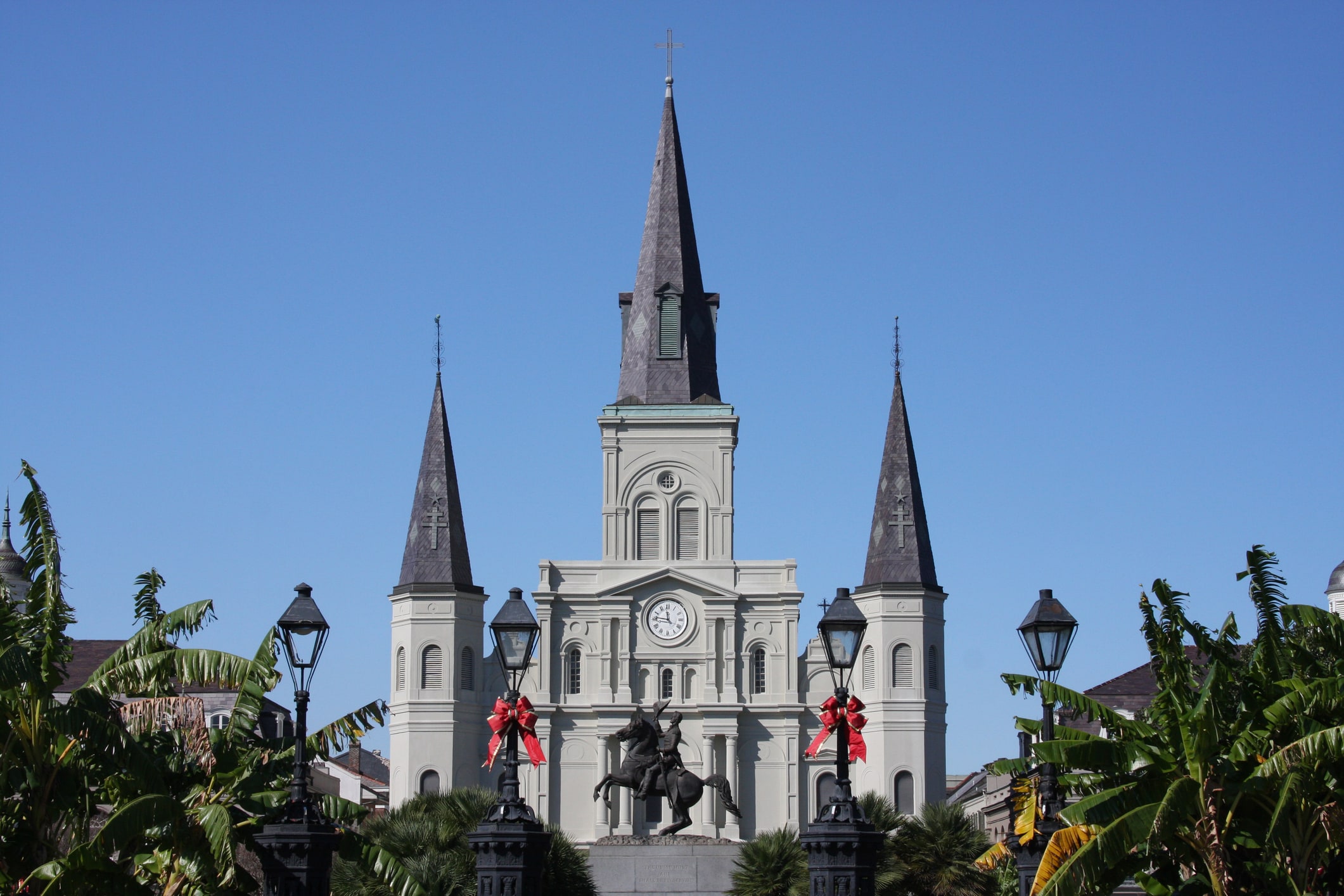 Christmas bows decorate lampposts at the St. Louis Cathedral in New Orleans, LA.