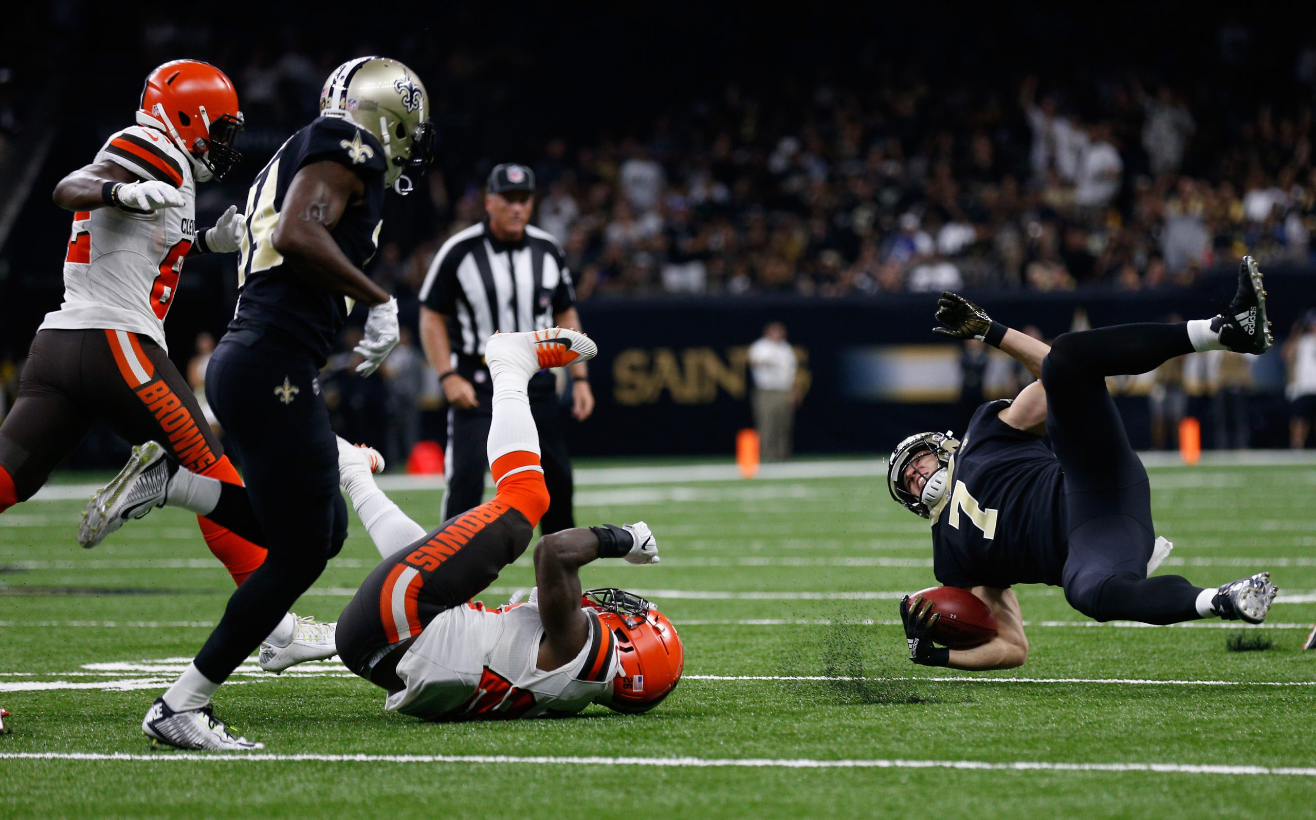 NEW ORLEANS, LA - SEPTEMBER 16: E.J. Gaines #28 of the Cleveland Browns tackles Taysom Hill #7 of the New Orleans Saints during the fourth quarter  at Mercedes-Benz Superdome on September 16, 2018 in New Orleans, Louisiana.  (Photo by Jonathan Bachman/Getty Images)