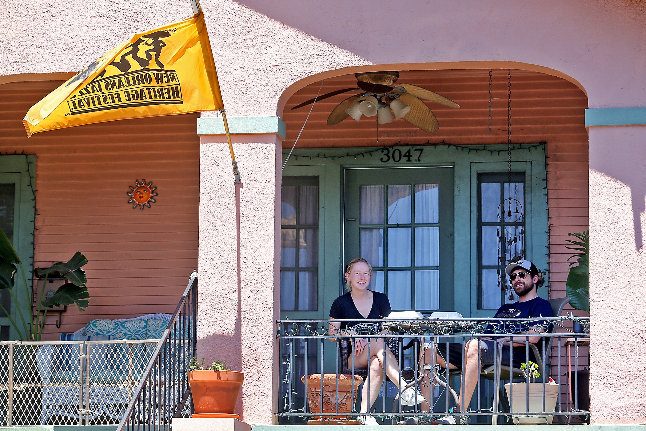 “Tired” nurse Andrea Olexa and her boyfriend Matthew Bosse celebrate Jazz Fest as best they can on their porch by listening to the WWOZ broadcast. This would have been the couple’s third Jazz Fest at their home near the Fair Grounds had the annual festival not been cancelled by the Covid-19 pandemic. Photographed on Friday, April 24, 2020. (Photo by Michael DeMocker)